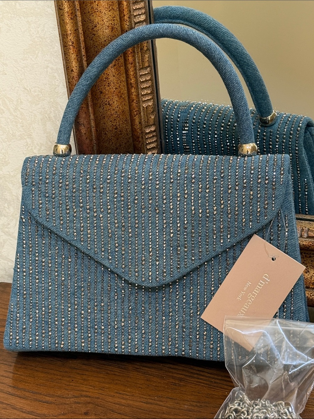 Denim Top-Handle or chain crossbody Bag with metallic embellishments.